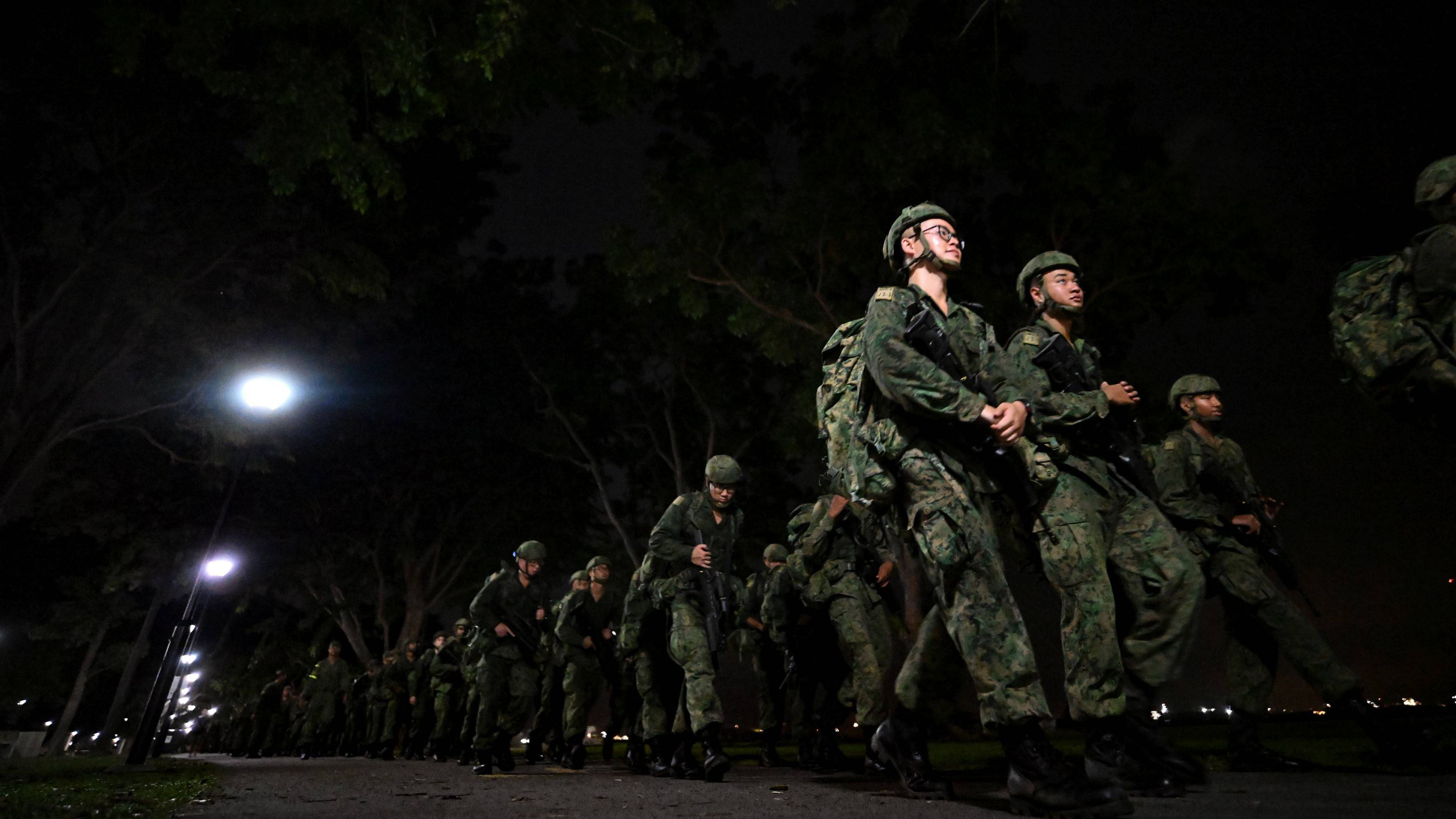Person in singapore army uniform marches along east coast park