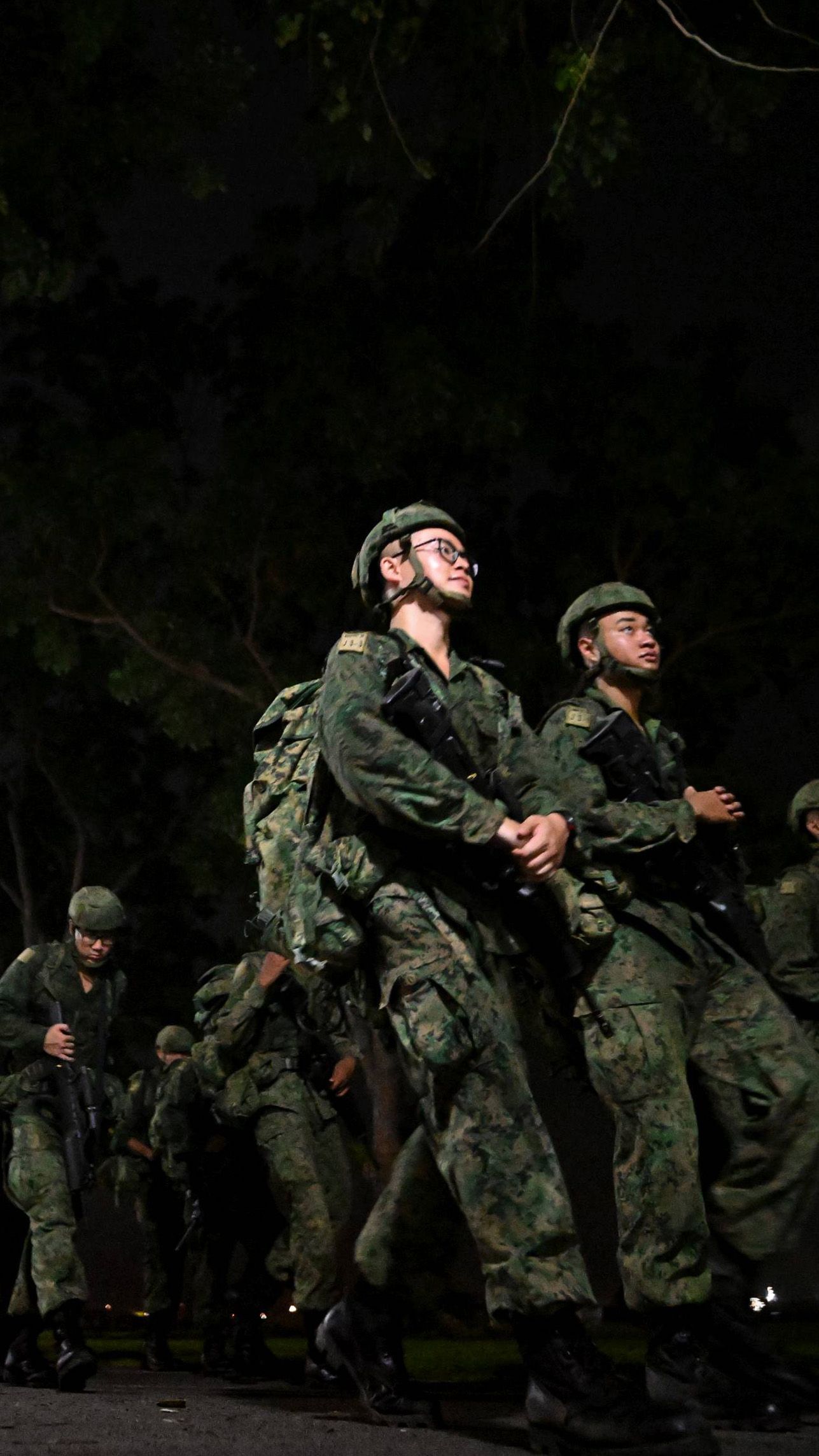 Person in singapore army uniform marches along east coast park